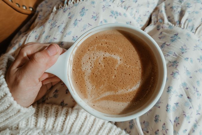 hand holding cup of coffee